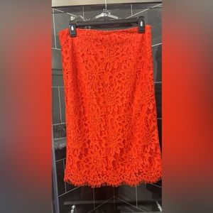 Red lace overlay skirt. Cotton and nylon with polyester lining